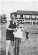 Black and white photo of adult and children at the beach